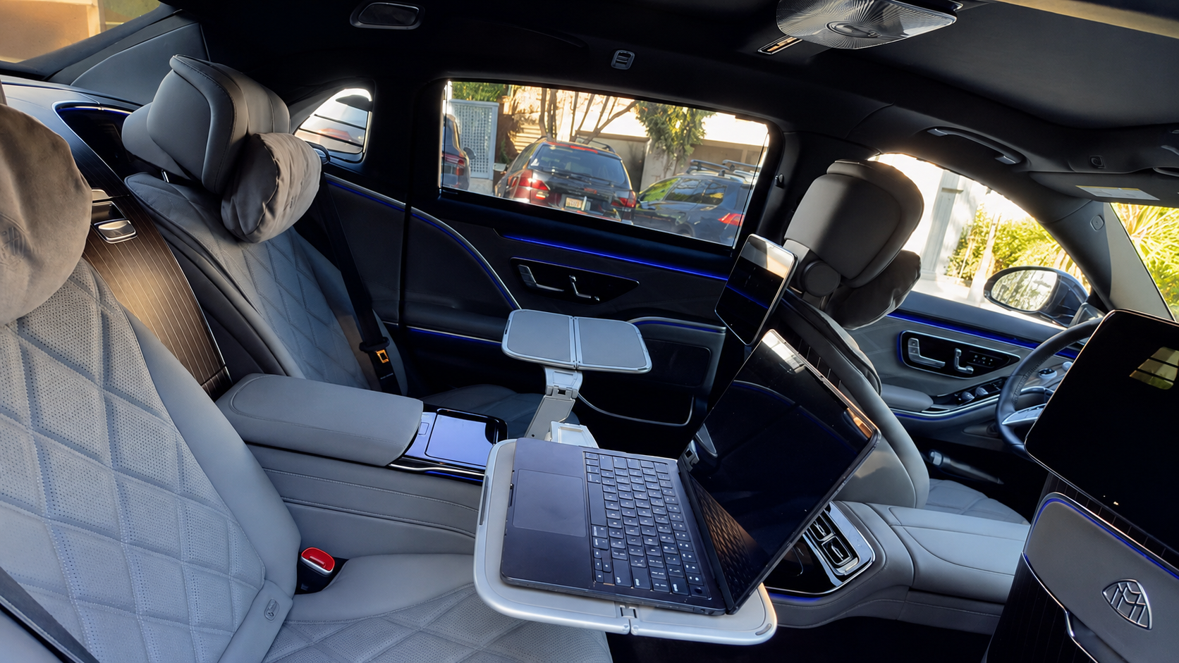 Mercedes-Maybach rear cabin with fold-out tray tables and laptop